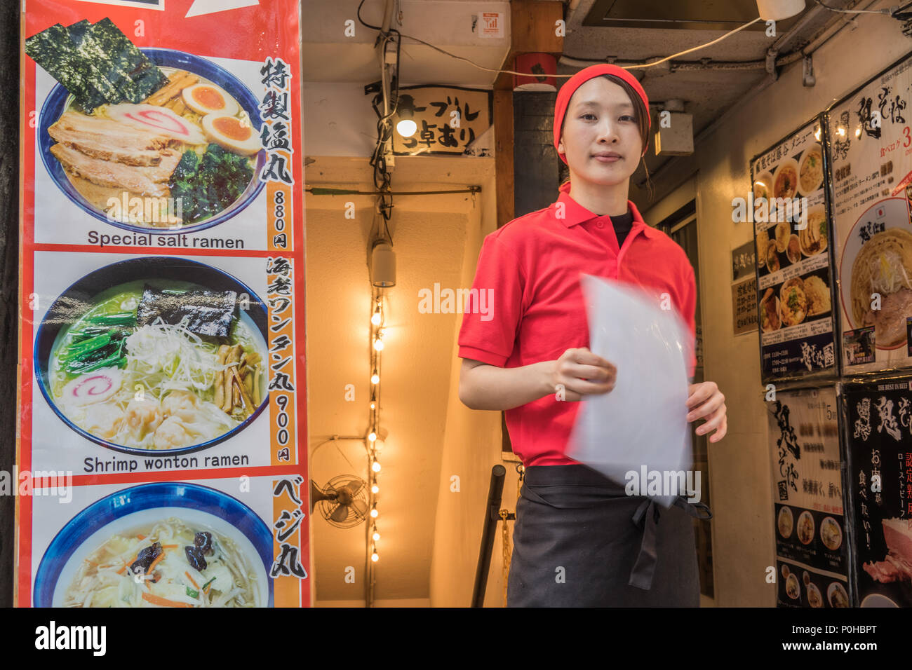 Woman worker at entrance to ramen restaurant, Shibuya, Tokyo, Japan Stock Photo