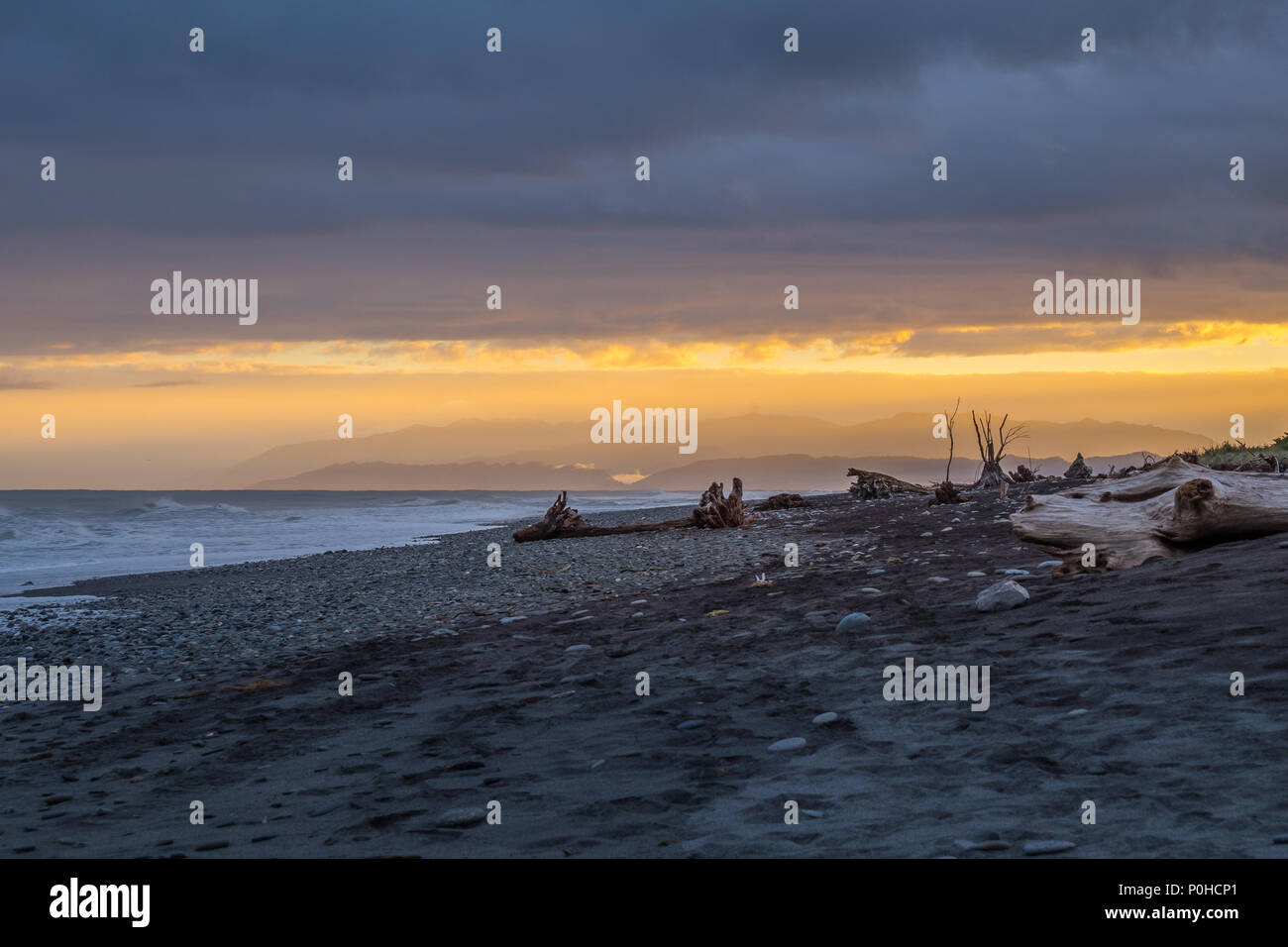 Hokitika beach in the morning with many pieces of wood in on the beach, Located on the west coast of New Zealand's South Island. Stock Photo
