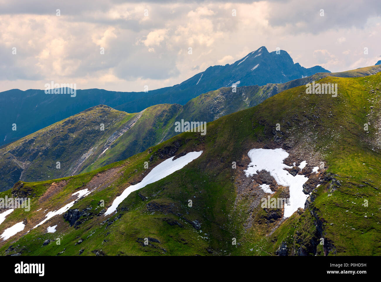 mountain peak behind the peaks. lovely scenery of Fagaras mountains on a cloudy summer day Stock Photo