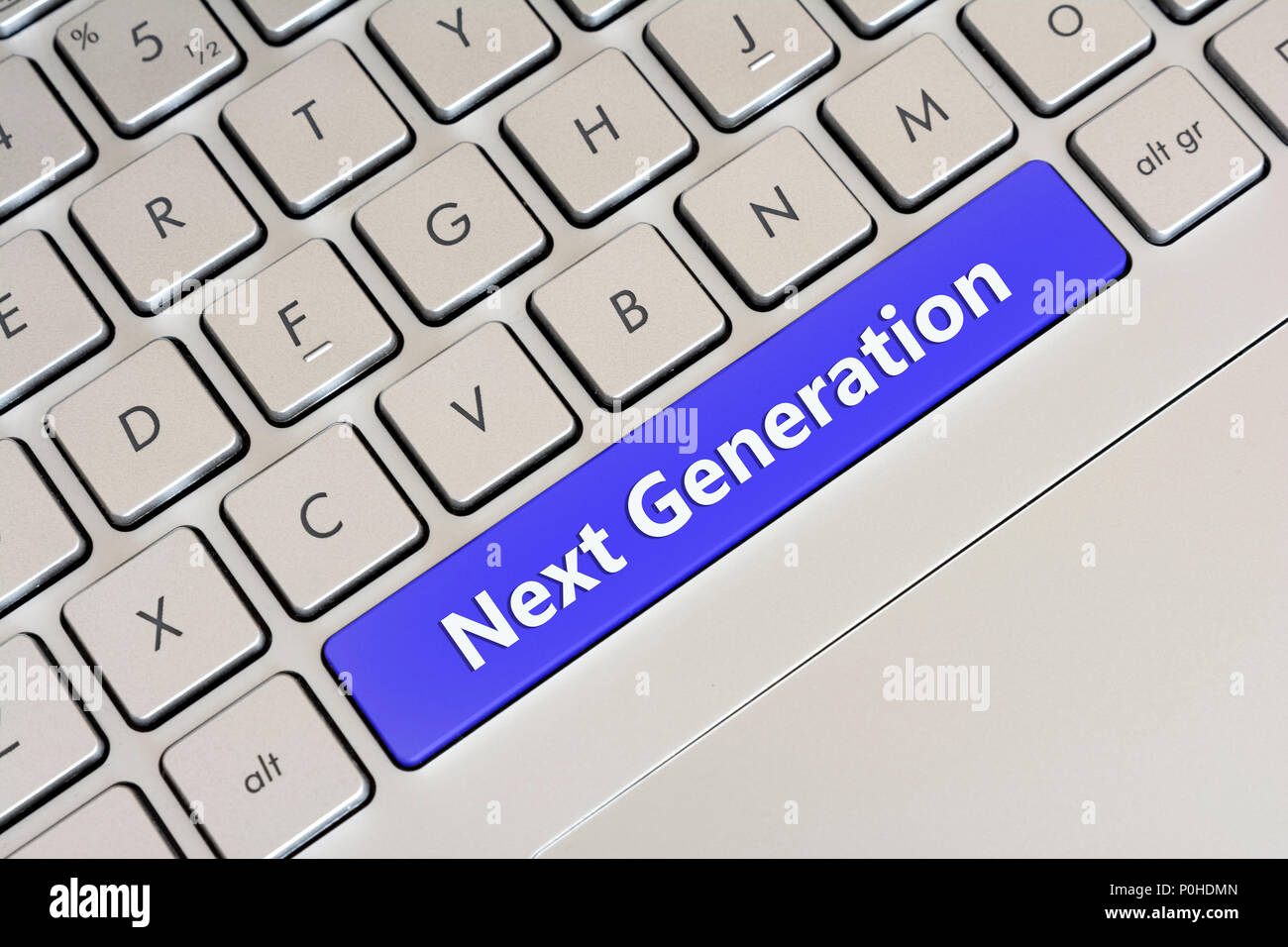 Clean Gray Laptop Keyboard With Blue Spacebar Writing 'Next Generation' Stock Photo