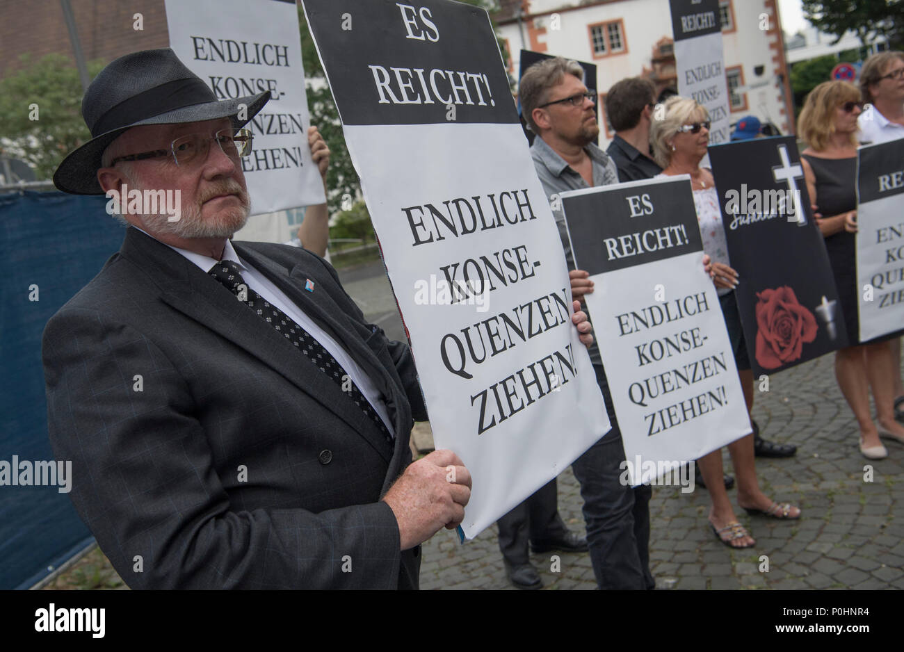 09 June 2018, Germany, Mainz: A few dozen people gather at a vigil organised by the Alternative for Germany (AfD) to commemorate 14-year-old murder victim Susanna. They carry signs reading 'Es reicht! Endlich Konsequenzen ziehen!' (lit. 'Enough! Consequences should follow'). An Iraqi refugee is suspected of having raped and murdered the girl. Photo: Boris Roessler/dpa Stock Photo