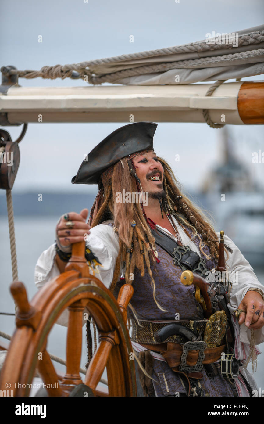 Poole, UK. 9th June, 2018. Look-a-like laughs as Captain Jack Sparrow on a boat at the Poole Harbour Boat Show, a free maritime festival in Dorset. Credit Thomas Faull/Alamy Live News. Stock Photo