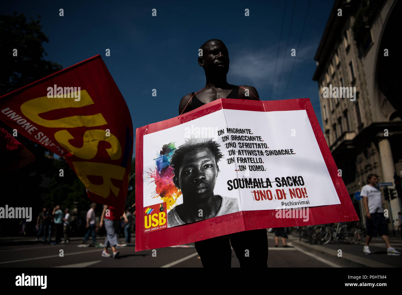 Milan, Italy - 9 June 2018: A protester holds a placard  with the photo of Soumaila Sacko, a  29 years old Malian farm worker migrant, murdered in a shooting last Sunday in the village of San Ferdinando in the southern Italian region of Calabria. Stock Photo