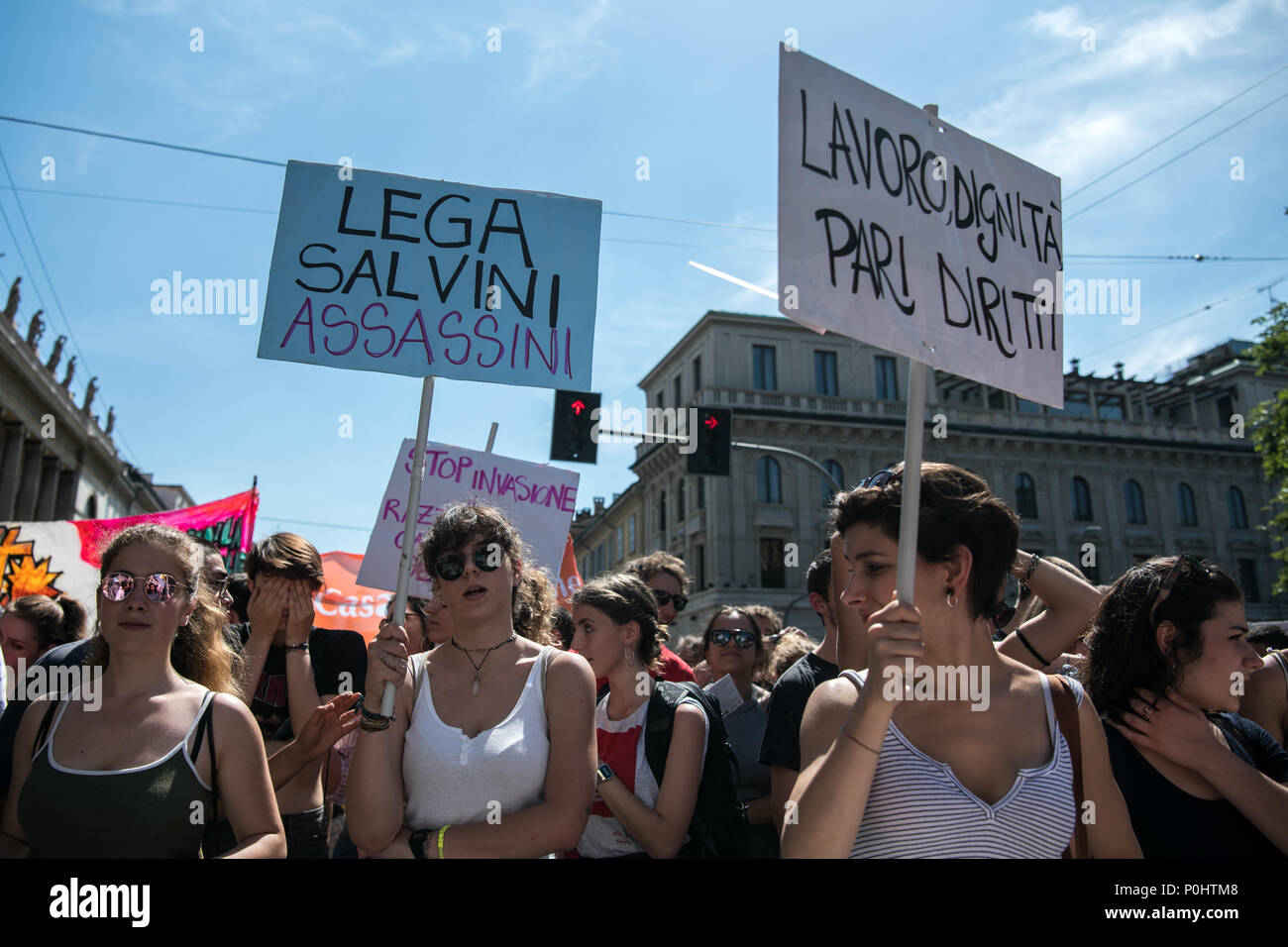 Milan, Italy - 9 June 2018: A young woman holds a placard  reading 'Lega Salvini Murderers' during an anti-racist rally against the killing of Soumaila Sacko, a  29 years old Malian farm worker migrant, murdered in a shooting last Sunday in the village of San Ferdinando in the southern Italian region of Calabria. Stock Photo