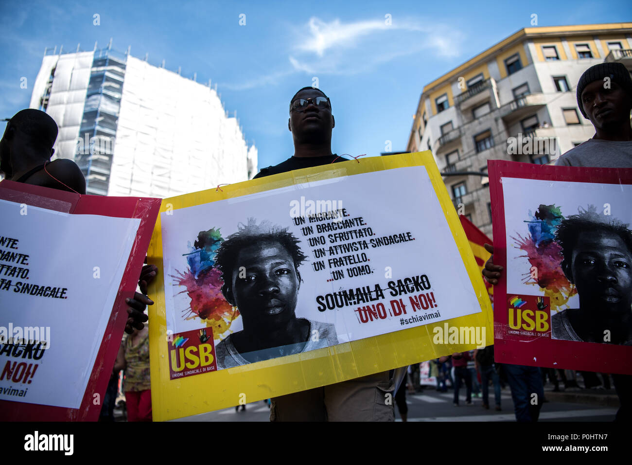 Milan, Italy - 9 June 2018: Protesters hold placards  with the photo of Soumaila Sacko, a  29 years old Malian farm worker migrant, murdered in a shooting last Sunday in the village of San Ferdinando in the southern Italian region of Calabria. Stock Photo