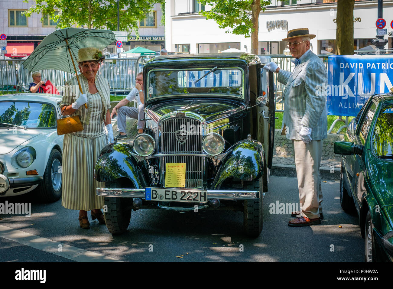 Berlin, Germany - june 09, 2018: Old Peugeot and older couple at Classic Days, a Oldtimer automobile exhibition showing vintage cars and historic vehicles at Kurfuerstendamm / Kudamm in Berlin Credit: hanohiki/Alamy Live News Stock Photo