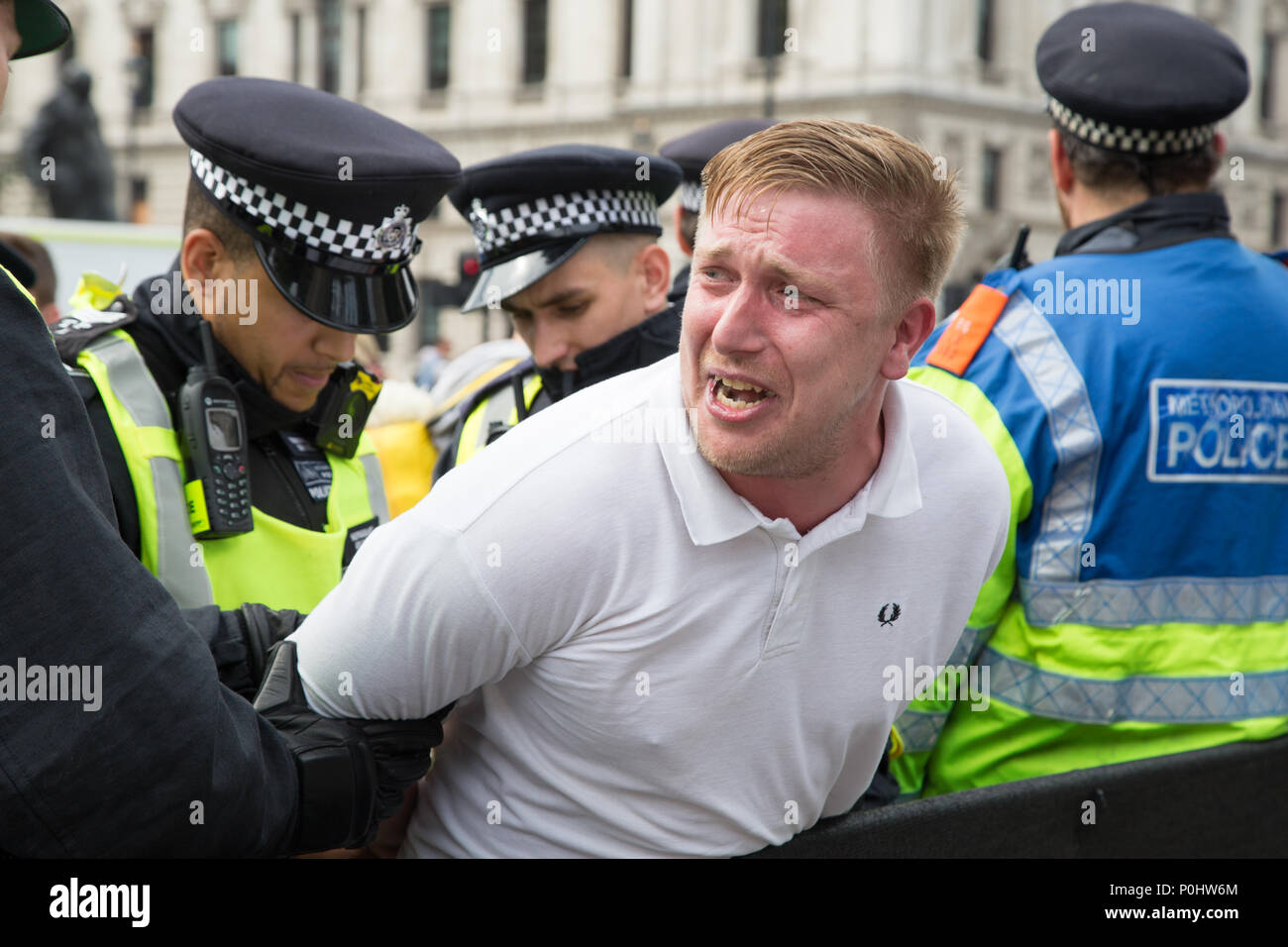 London UK 9th June 2018 A Tommy Robinson supporter cries as he is  handcuffed and temporally detained by police, moments after performing a Nazi salute and holding up a banner reading “f**k Islam”. Stock Photo