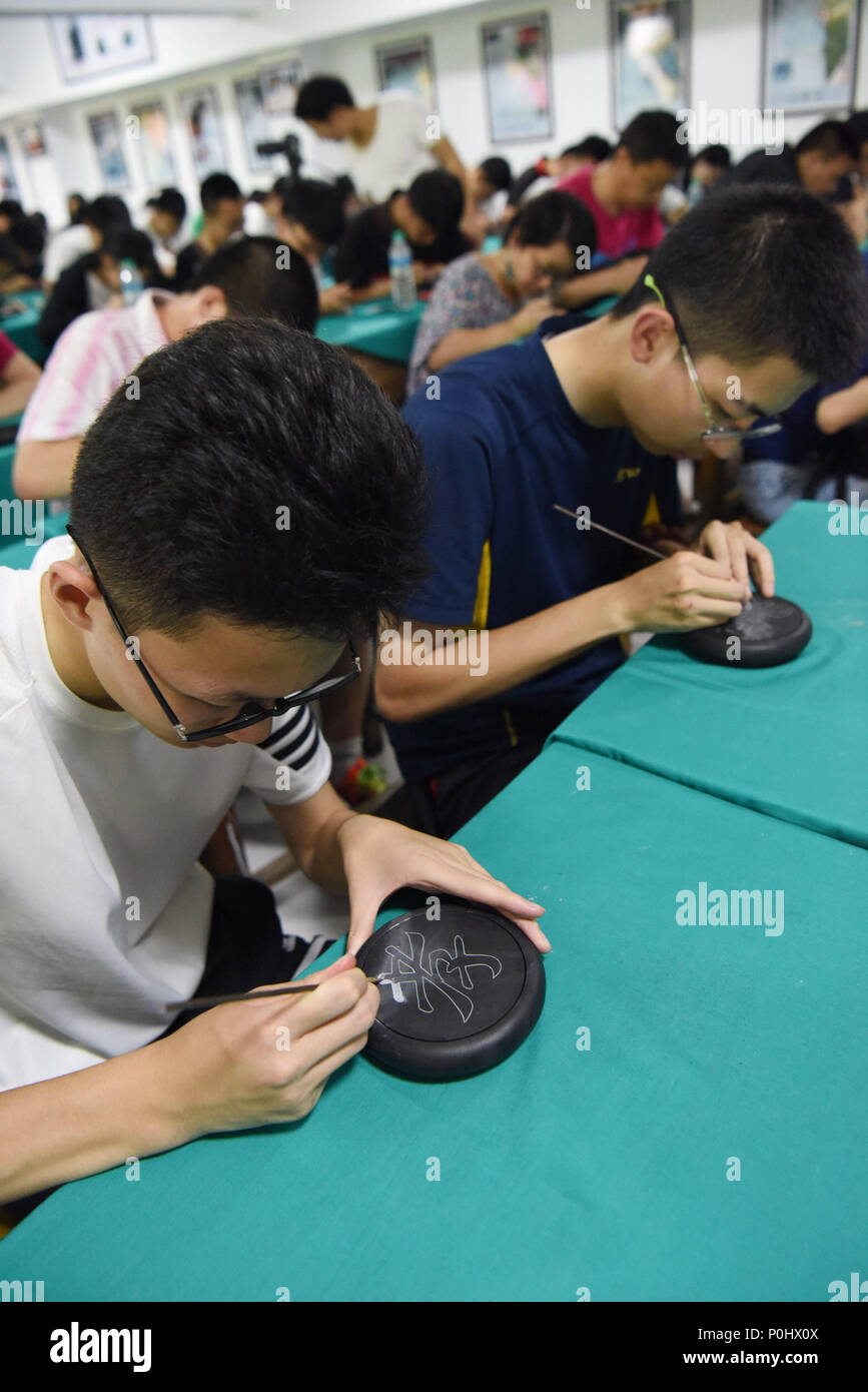 Wuyuan, China's Jiangxi Province. 9th June, 2018. Students experience inkstone carving in Wuyuan, east China's Jiangxi Province, June 9, 2018. Activities were held around China to celebrate the Cultural and Natural Heritage Day on Saturday. Credit: Song Zhenping/Xinhua/Alamy Live News Stock Photo