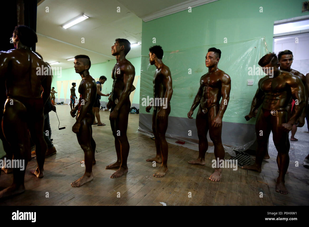 Yangon, Myanmar. 9th June, 2018. Contestants line up to go on the stage of the bodybuilding and physique sports competition, which is an Olympic Day activity, at the Myanmar Convention Center in Yangon, Myanmar, June 9, 2018. Credit: U Aung/Xinhua/Alamy Live News Stock Photo