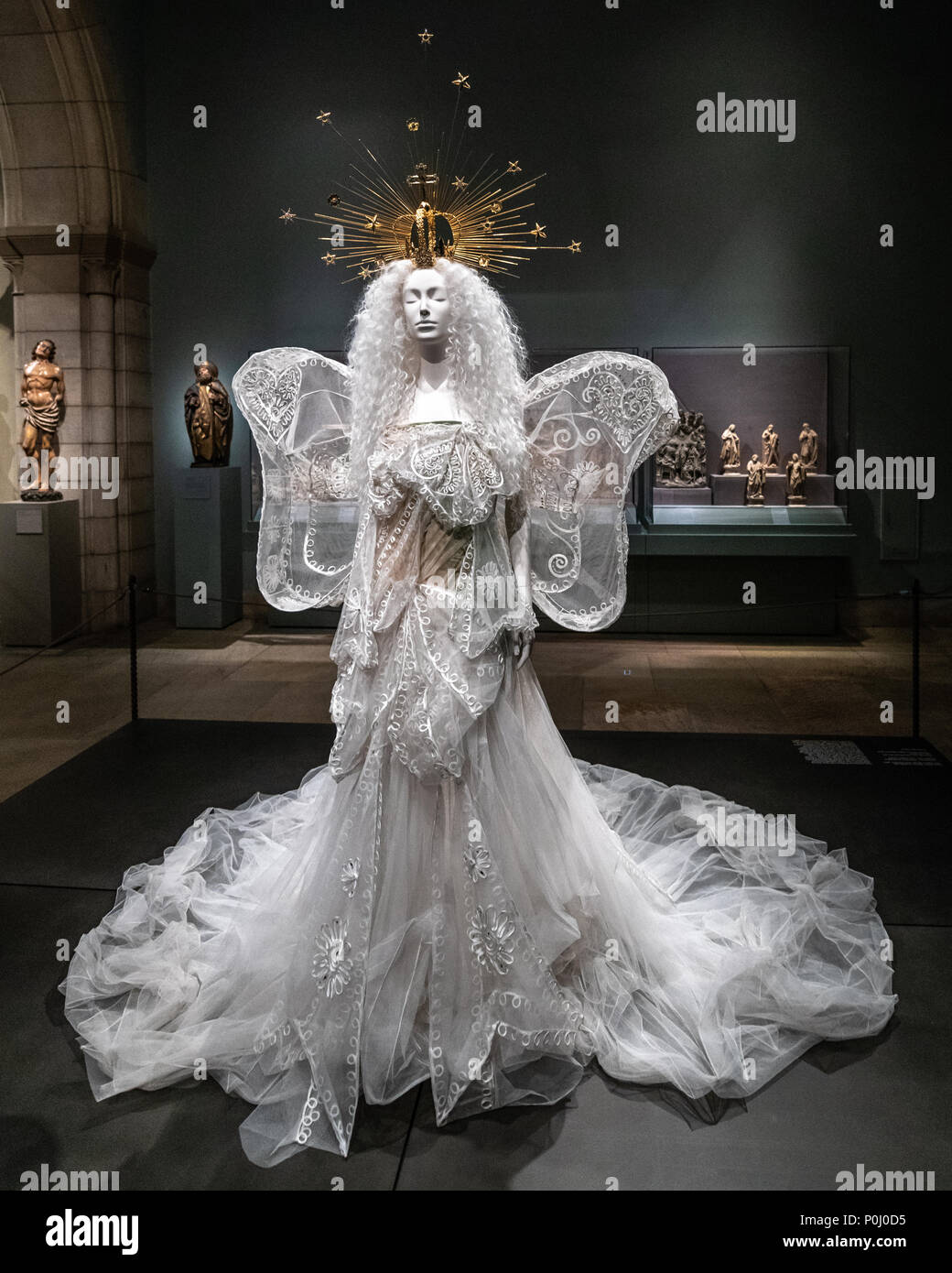 New York, USA. 9th June 2018. NEW YORK, USA, 9 June 2018. 'Madonna' Wedding ensemble designed by John Galliano for the House of Dior on display at the Metropolitan Museum of Art for the 'Heavenly Bodies' exhibition. This ensemble is made of white silk tulle, embroidered white silk and metal thread.  Photo by Enrique Shore Credit: Enrique Shore/Alamy Live News Stock Photo