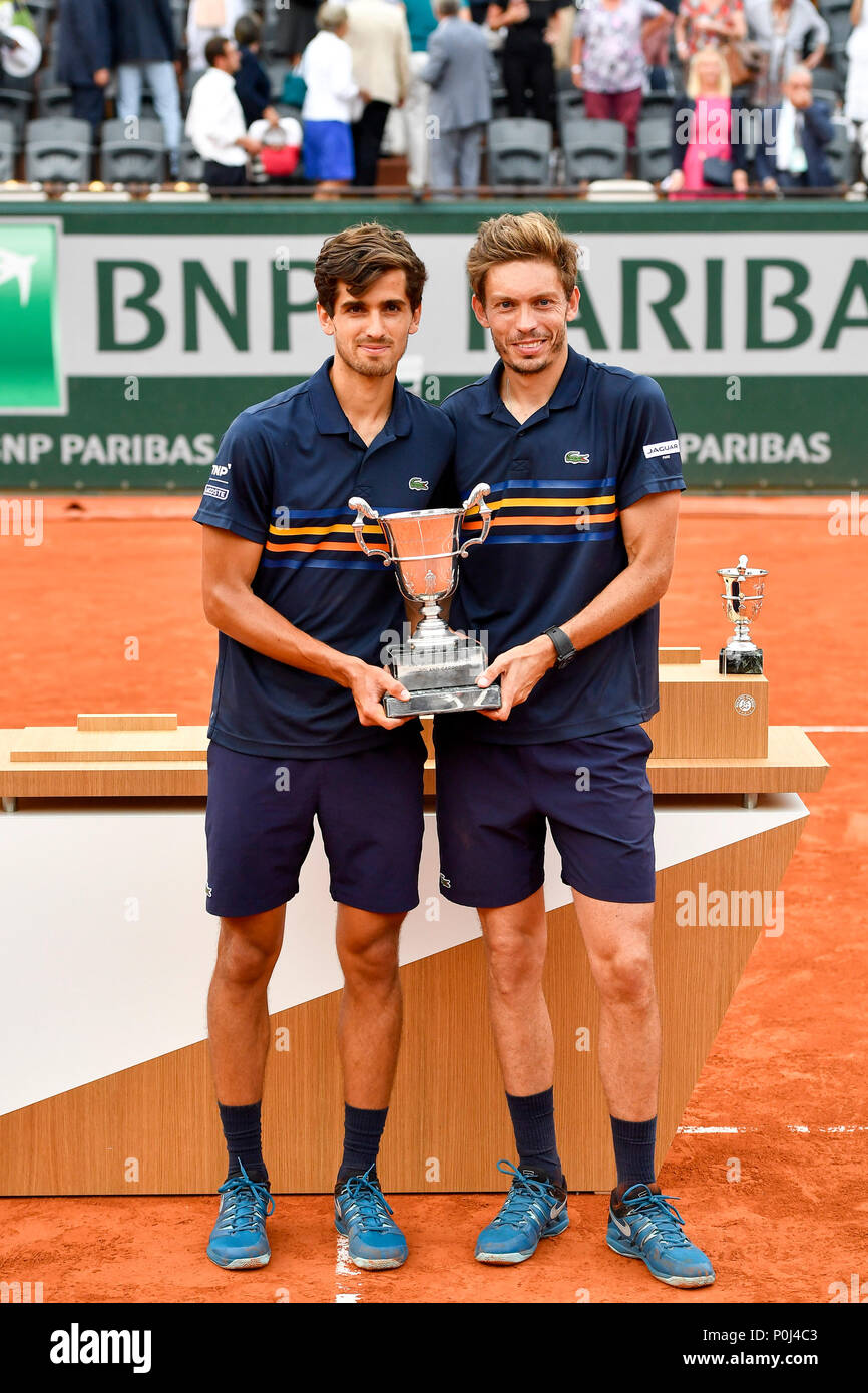 Paris. 9th June, 2018. Pierre-Hugues Herbert (L) and Nicolas Mahut of  France react during the awarding ceremony for men's doubles at the French  Open Tennis Tournament 2018 in Paris, France on June