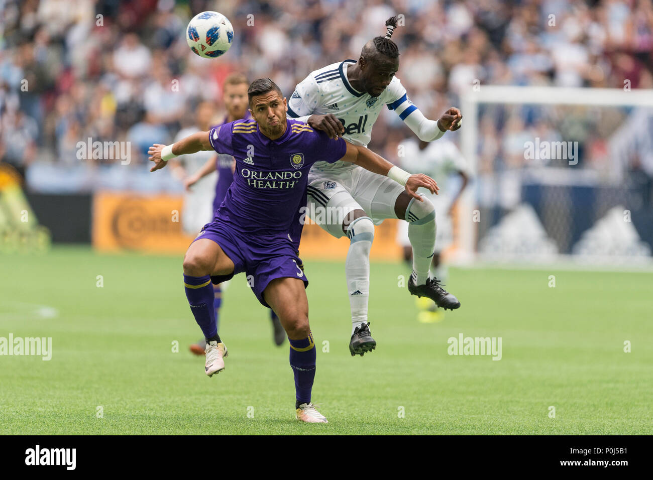 Vancouver, Canada. 9 June 2018. Amro Tarek (3) of Orlando City (left) and Kei Kamara (23) of Vancouver Whitecaps in action for the ball. Final Score Vancouver 5, Orlando 2.  Vancouver Whitecaps vs Orlando City SC BC Place.  © Gerry Rousseau/Alamy Live News Stock Photo