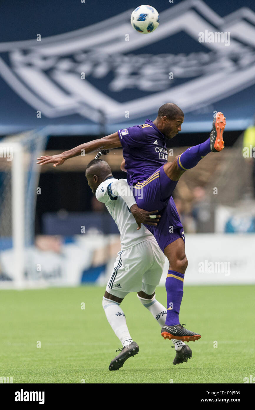 Vancouver, Canada. 9 June 2018. Kei Kamara (23) of Vancouver Whitecaps (white) and Chris Schuler of Orlando City vie for the ball. Final Score Vancouver 5, Orlando 2.  Vancouver Whitecaps vs Orlando City SC BC Place.  © Gerry Rousseau/Alamy Live News Stock Photo