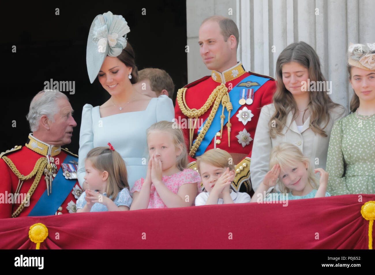 London, UK. 9th June 2018. Princess Charlotte, Savannah Phillips and Prince George clap whilst Isla Phillips salutes the crowd at the end of the National Anthem. Buckingham Palace blacony, Trooping the Colour, the Queens Birthday Parade, London Credit: amanda rose/Alamy Live News Stock Photo