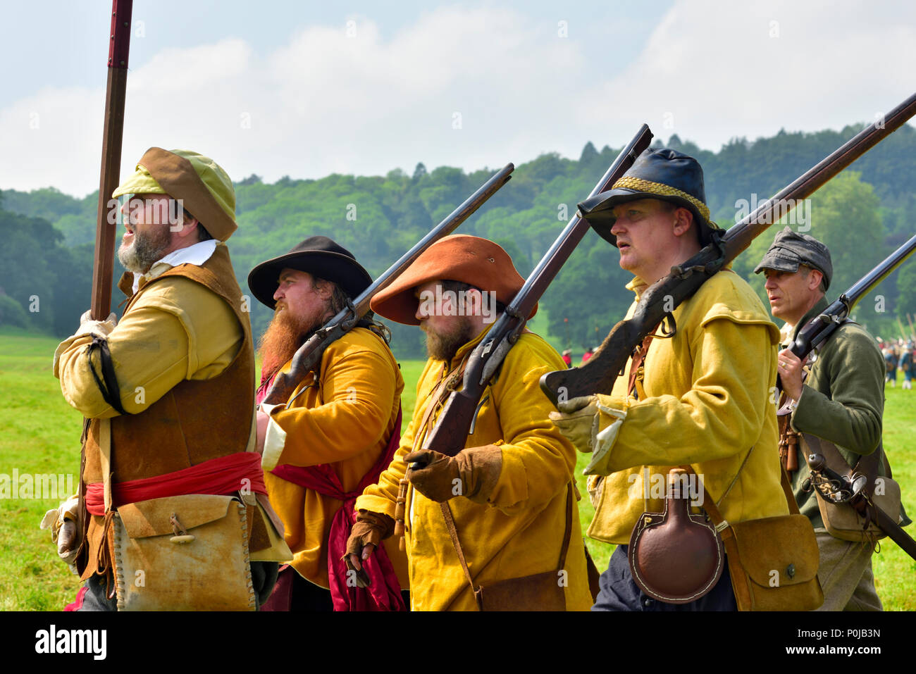 Small group of 17th century musketeers in buff coats marching with muskets over shoulder, English Civil war, 1641 to 1652 Stock Photo