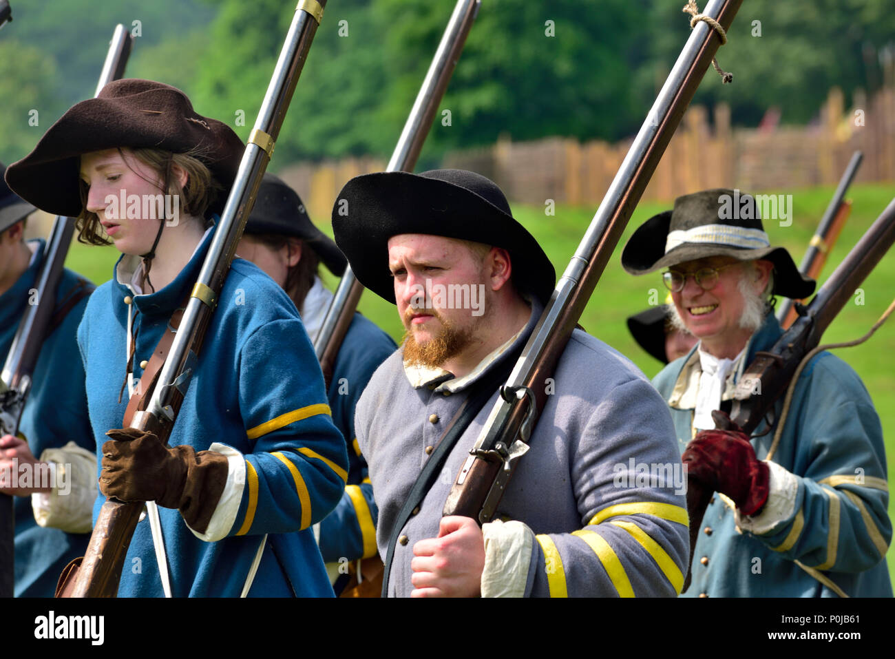 Small group of 17th century musketeers marching with muskets over shoulder Stock Photo