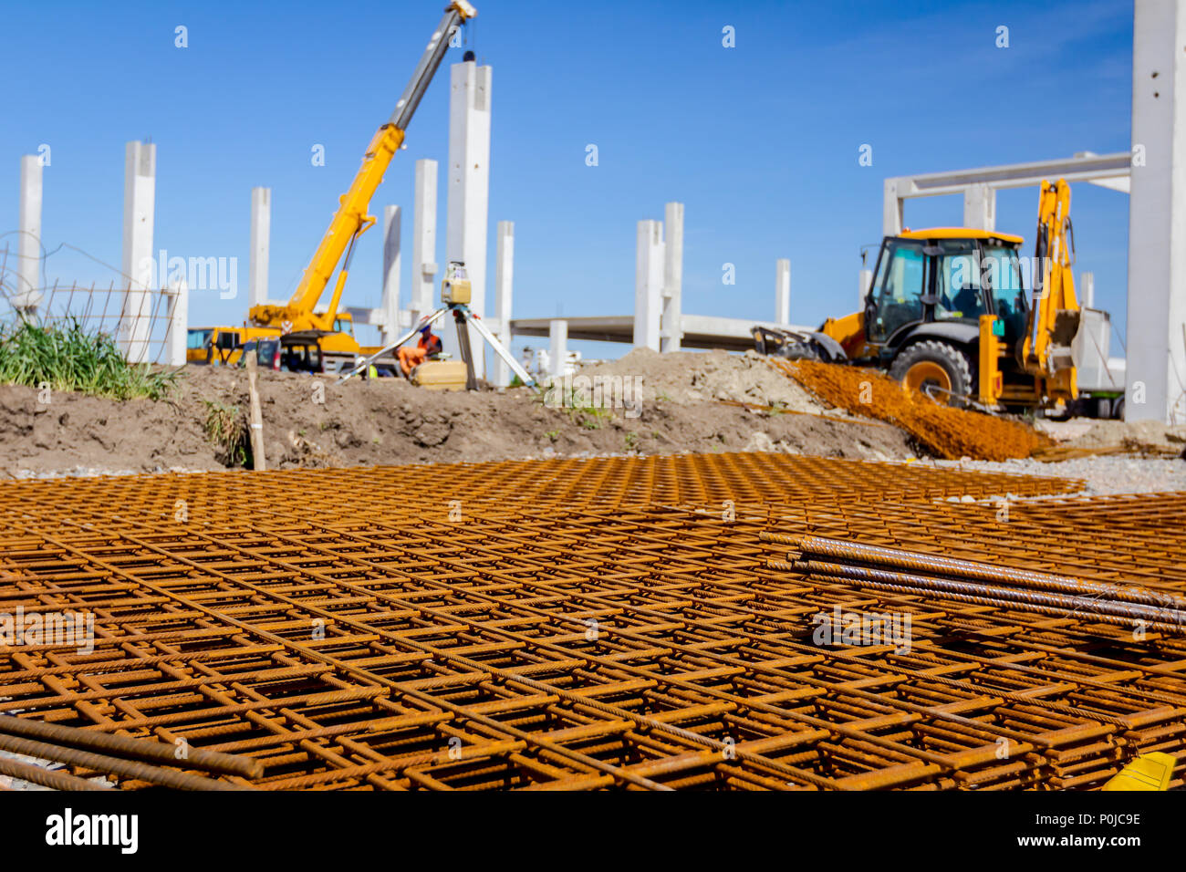 View on rusty square reinforcement for concrete, construction site is in  background Stock Photo - Alamy