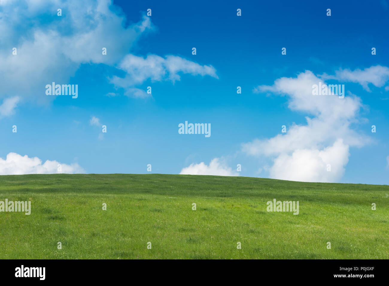 Rolling green hills and blue sky with clouds Stock Photo - Alamy