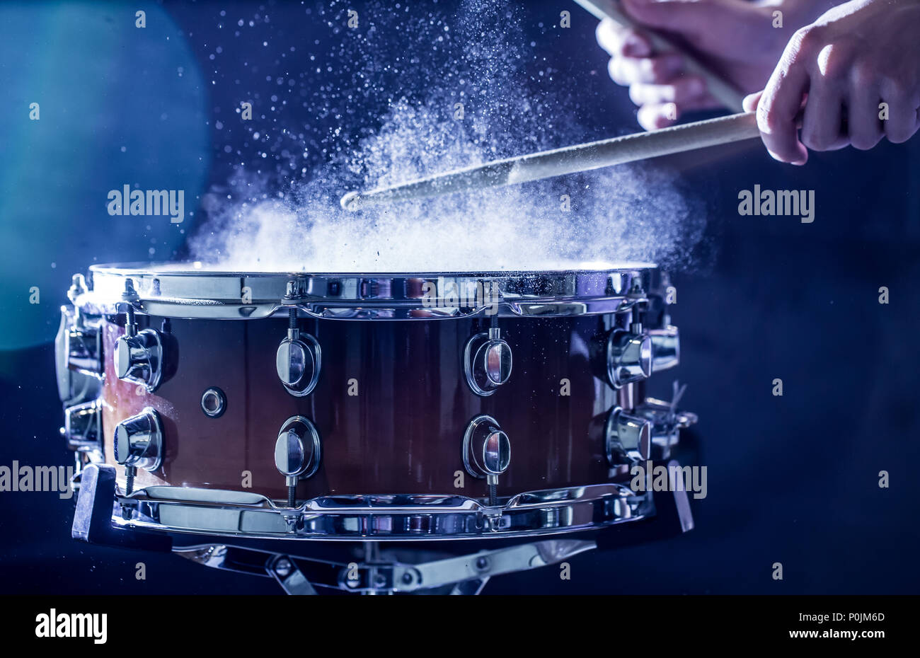 man plays musical percussion instrument with sticks, a musical concept, beautiful lighting on