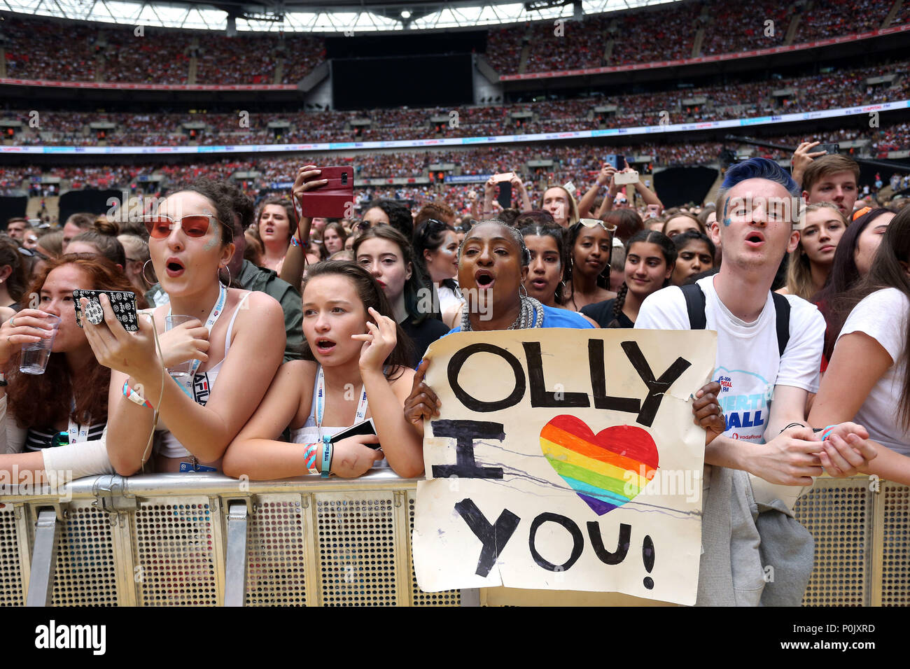 A fan of Olly Alexander of Years & Years in the crowd during Capital's Summertime Ball with Vodafone at Wembley Stadium, London. Stock Photo