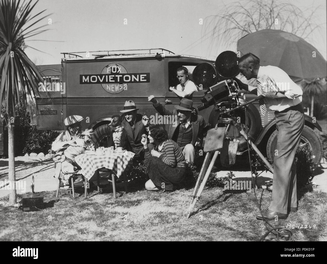 Description: A Movietone filming team shooting a newsreel. This production company producing cinema and newsreels was known in the United States as Fox Movietone News (1928-1963) and in the United Kingdom as British Movietone News (1929-1979)..  Original Film Title: FILM HISTORY: TWENTIETH CENTURY FOX STUDIOS.  English Title: FILM HISTORY: TWENTIETH CENTURY FOX STUDIOS.  Year: 0. Stock Photo