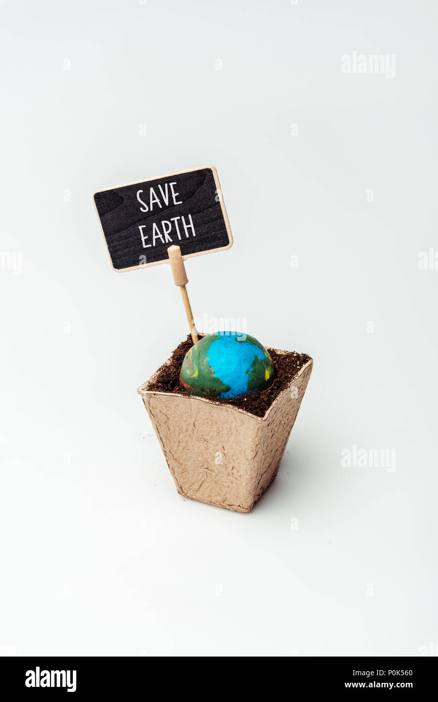earth model and sign save earth in flower pot isolated on white, earth day concept Stock Photo