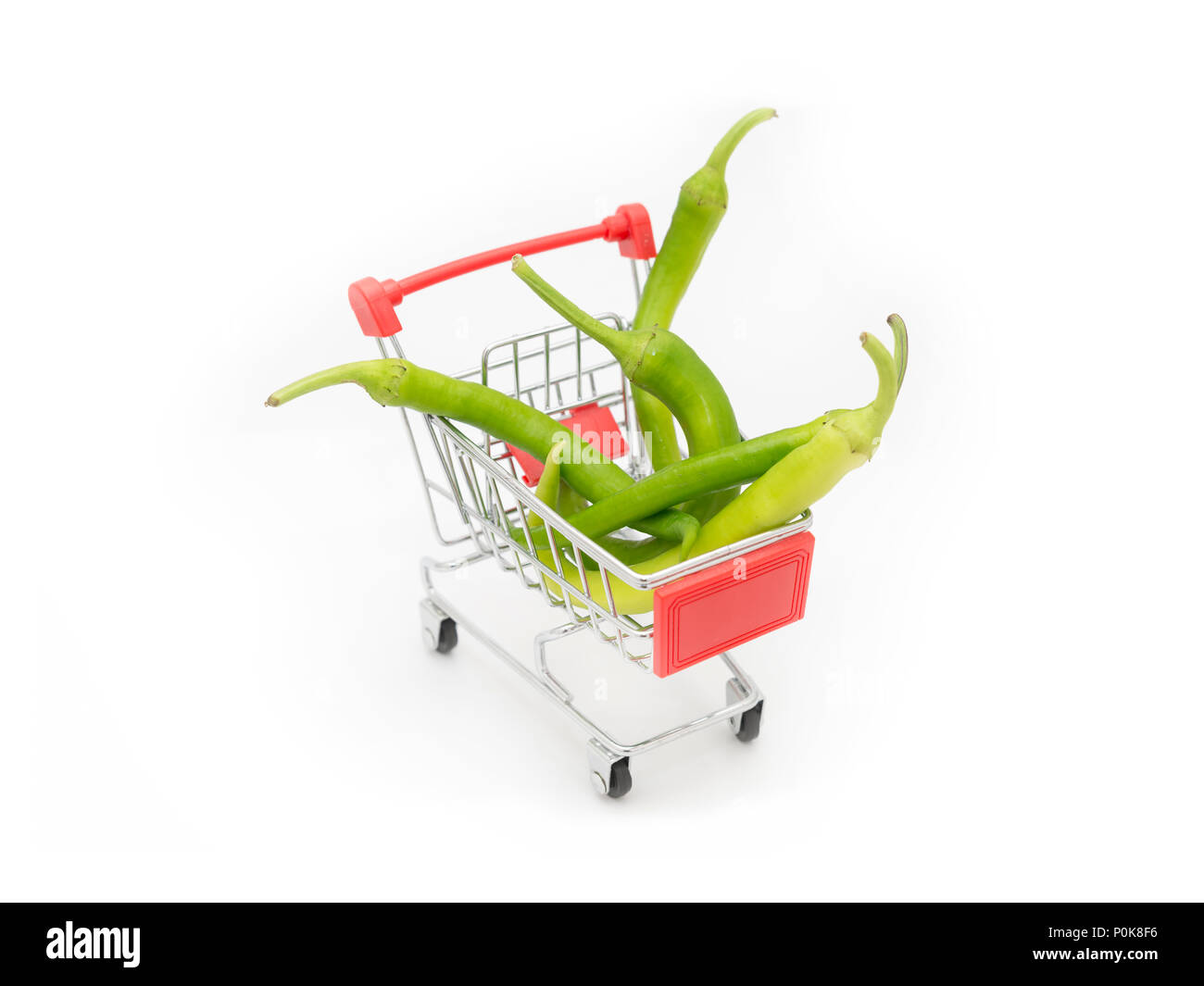 Green Peppers Loaded On A Shopping Cart, Isolated On White Background Stock Photo