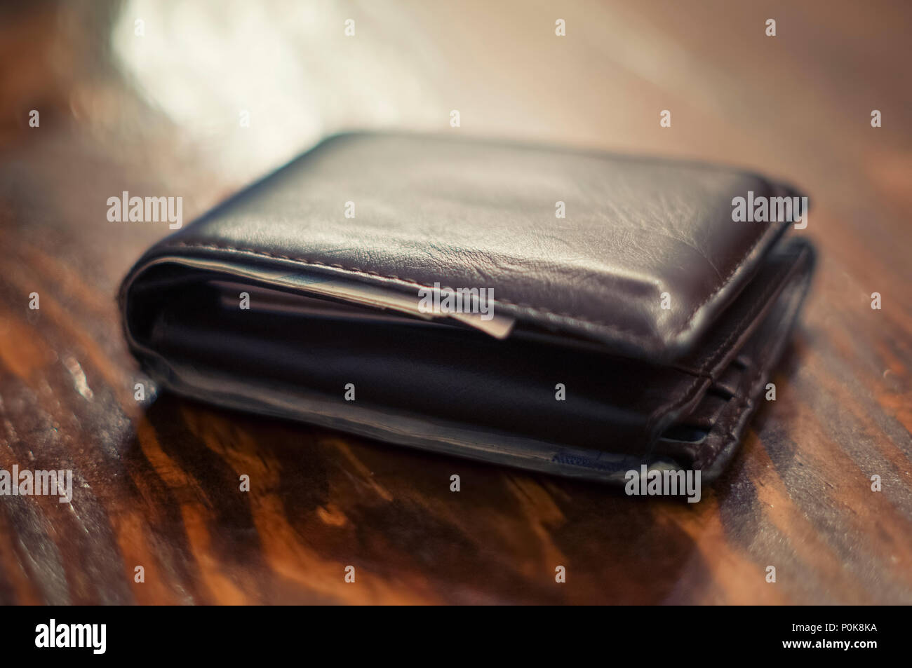 Leather Wallet On A Wooden Table Stock Photo