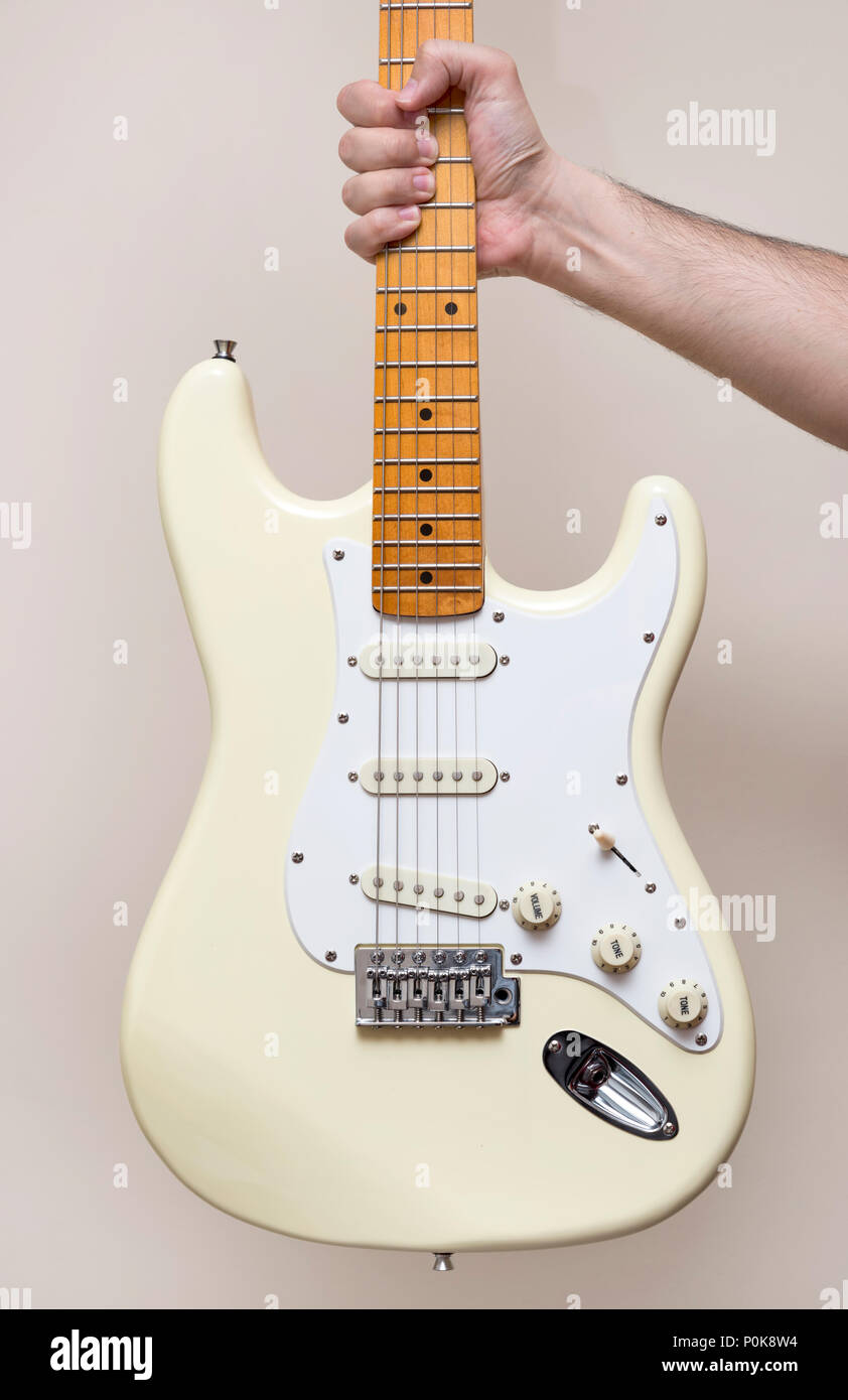 Hand Holding White Vintage Electric Guitar Stock Photo