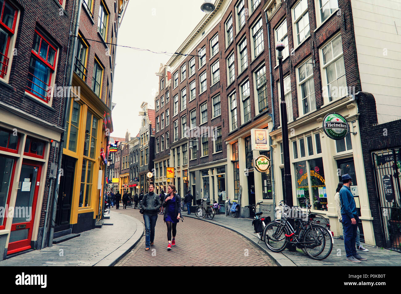 People walking at one of the streets in the old town of Amsterdam which has many coffee shops,bars and cafe's. Netherlands Stock Photo