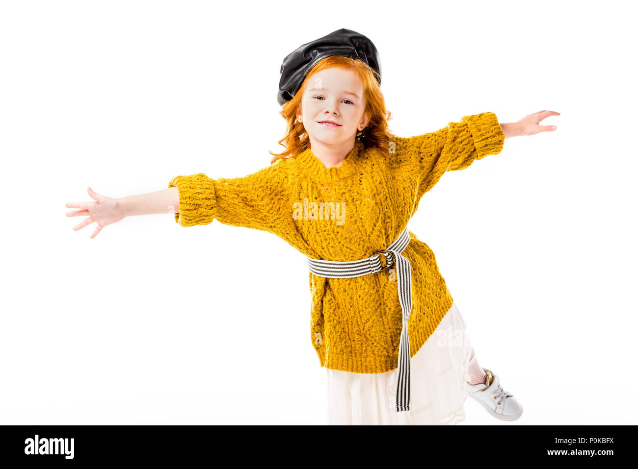 red hair child standing on one leg with open arms isolated on white Stock Photo Alamy