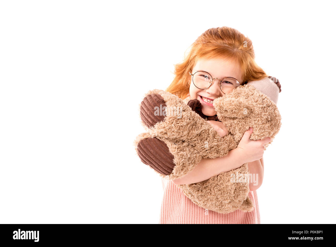 kid hugging teddy bear