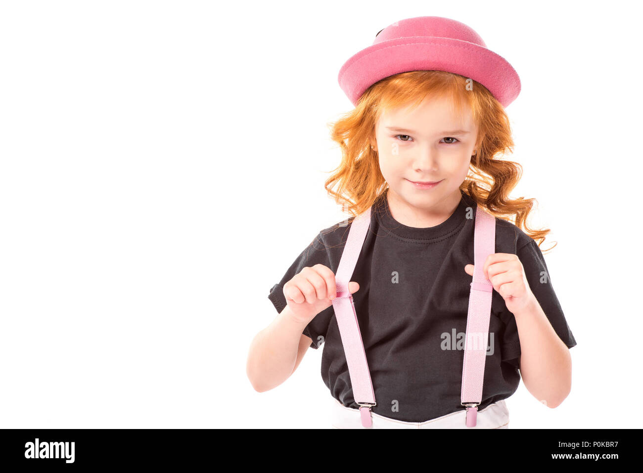 funny red hair kid holding pink suspenders isolated on white Stock