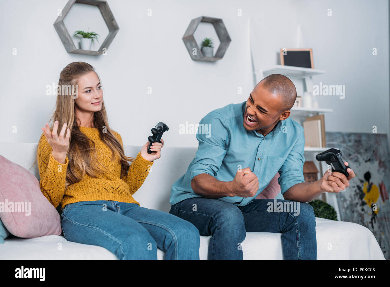 Joyful couple winning video games with joystick on console in studio.  Boyfriend and girlfriend playing online game with controller to win,  feeling happy and relaxed with leisure activity Stock Photo - Alamy