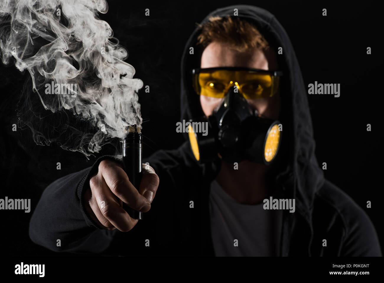 cigarette smoke filter mask Man wearing protective filter mask activating electronic cigarette Stock  Photo