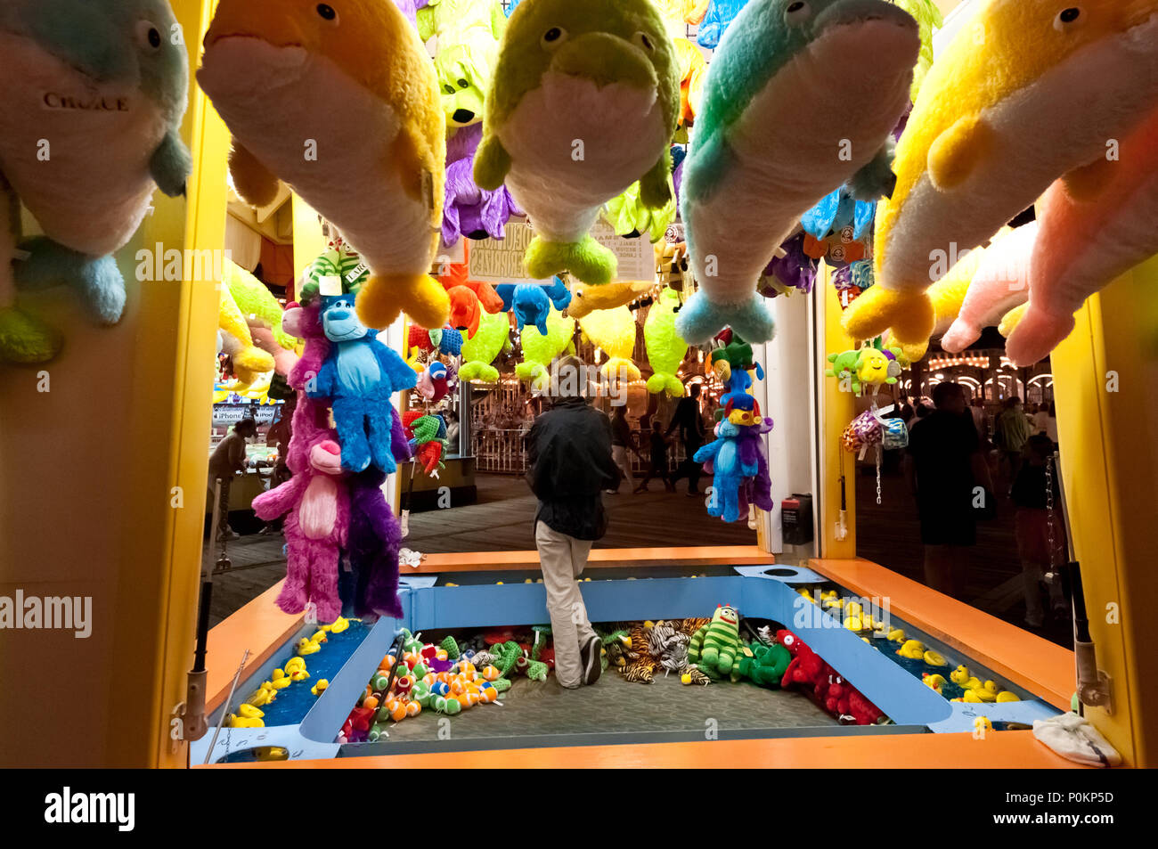 Carny booth with lots of stuffed animals at an ocean boardwalk in New