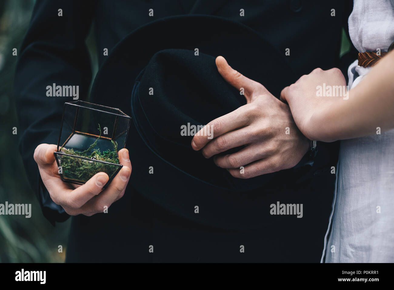 cropped shot of young couple standing together and man holding jewelry box with engagement ring Stock Photo