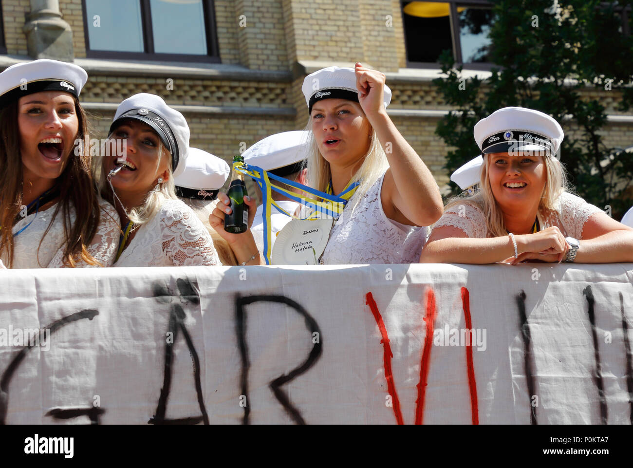 Karlstad, Sweden - June 8, 2018: Close up of Swedish happy students wearing traditional student caps celebrating their degree by riding a flatbed truc Stock Photo