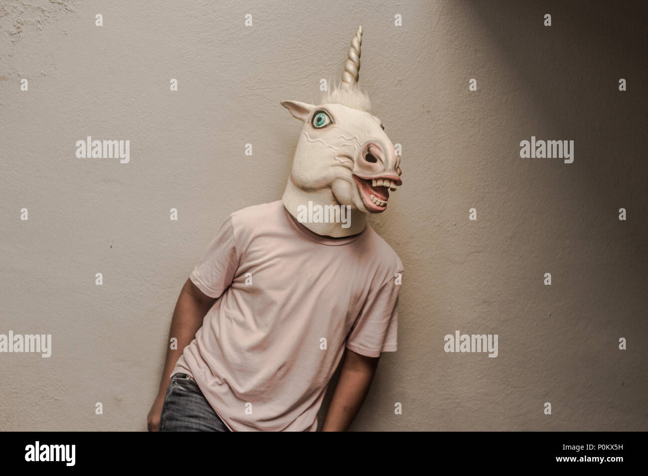 Photograph of a teen with a funny unicorn mask Stock Photo - Alamy
