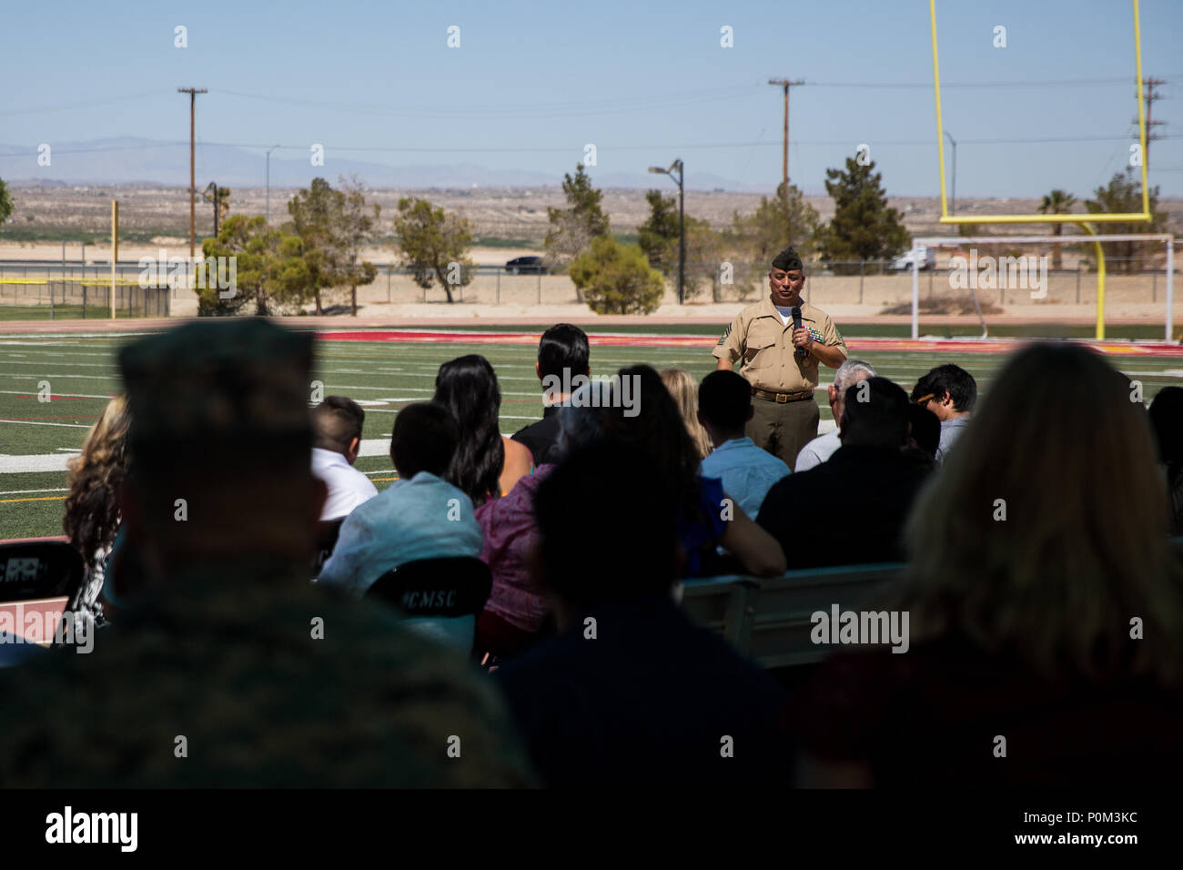 Master Gunnery Sgt. Joseph Lopez, supply chain administration and operations specialist, Headquarters Battalion, speaks during his retirement ceremony at Felix Field aboard the Marine Corps Air Ground Combat Center, Twentynine Palms, Calif., June 1, 2018. Lopez is retiring after 30 years of faithful service to country and Corps. (U.S. Marine Corps photo by Lance Cpl. Isaac Cantrell) Stock Photo