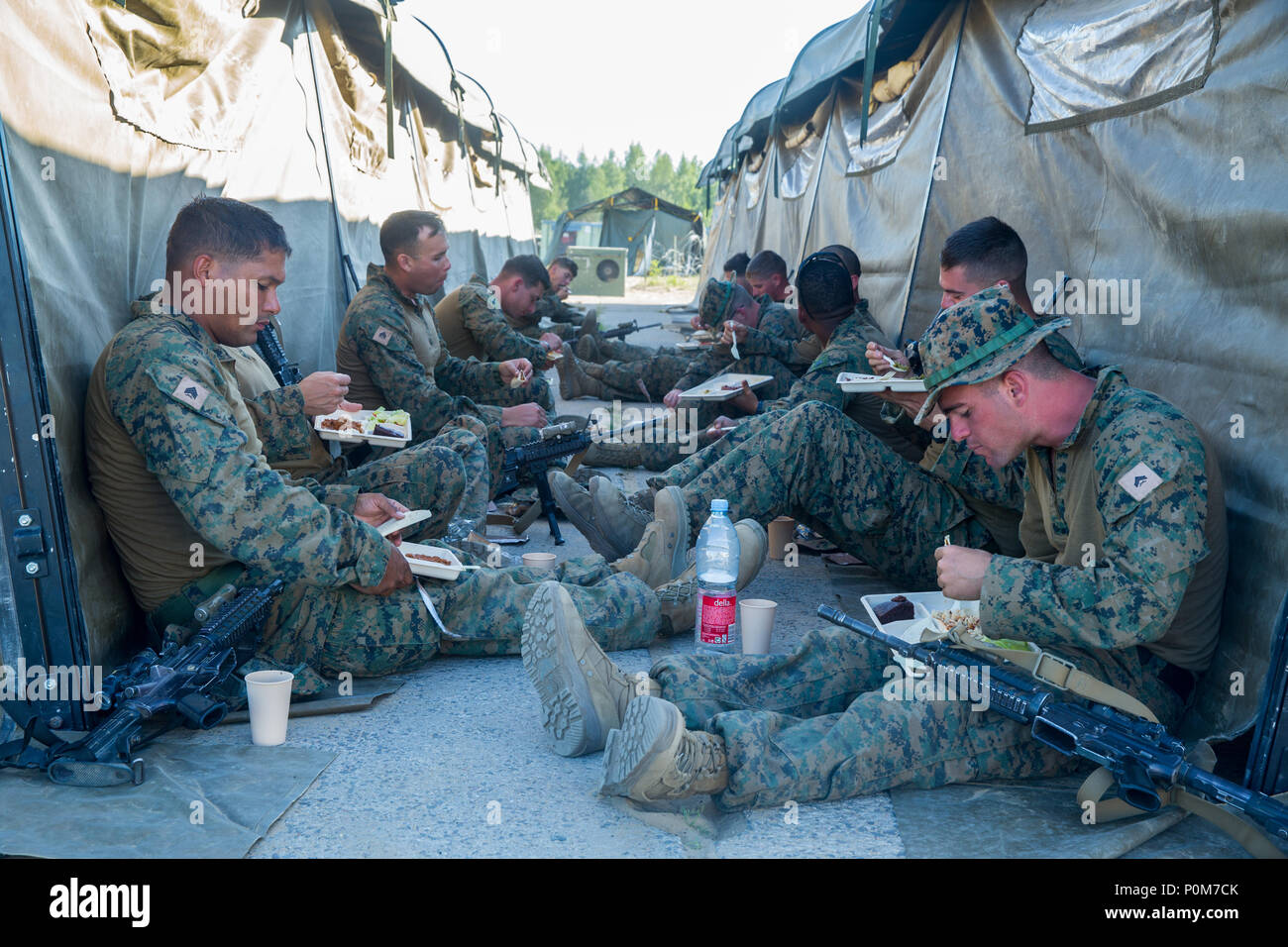 U.S. Marines with 1st Battalion, 6th Marines eat dinner from the expeditionary field kitchen