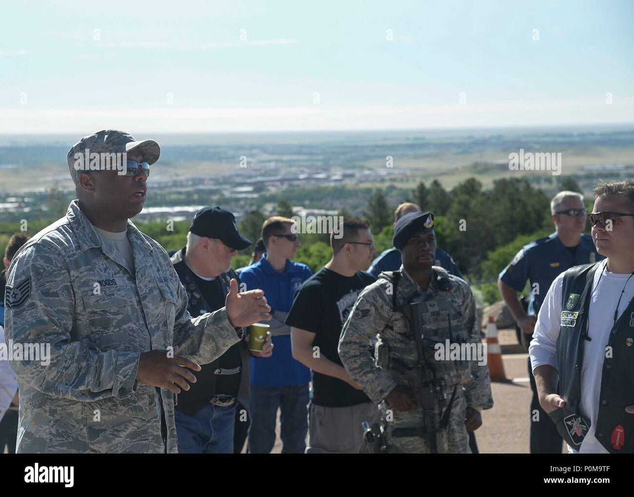 CHEYENNE MOUNTAIN AIR FORCE STATION, Colo.—Tech. Sgt. Wade H. Woods II, 21st Space Wing Non-Commissioned Officer In Charge of occupational safety, gives a safety brief before the Fallen Officers Memorial Motorcycle Ride, June 1, 2018 at Cheyenne Mountain Air Force Station, Colorado. The ride began in 2014 with only 12 riders. Four years and five rides years later, 137 riders attended to honor fallen military and civilian police officers. (U.S. Air Force photo by Staff Sgt. Emily Kenney) Stock Photo