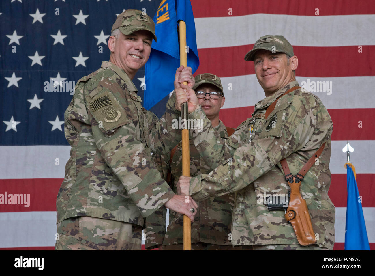 Maj. Gen. Barre Seguin, 9th Air and Space Expeditionary Task Force—Afghanistan commander receives the guide-on from Brig. Gen. Craig Baker, 455th Air Expeditionary Wing commander, during a change of command ceremony on Bagram Airfield, Afghanistan, June 6, 2018. Baker relinquished command and will be continuing on with his career as the 12th Air Force commander. (U.S Air Force photo by Staff Sgt. Kristin High) Stock Photo