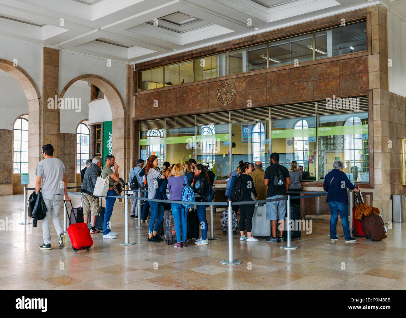Passengers queue to purchase tickets at Lisbon's Santa Apolonia train station connecting Portugal's inter-city train network is accessible Stock Photo