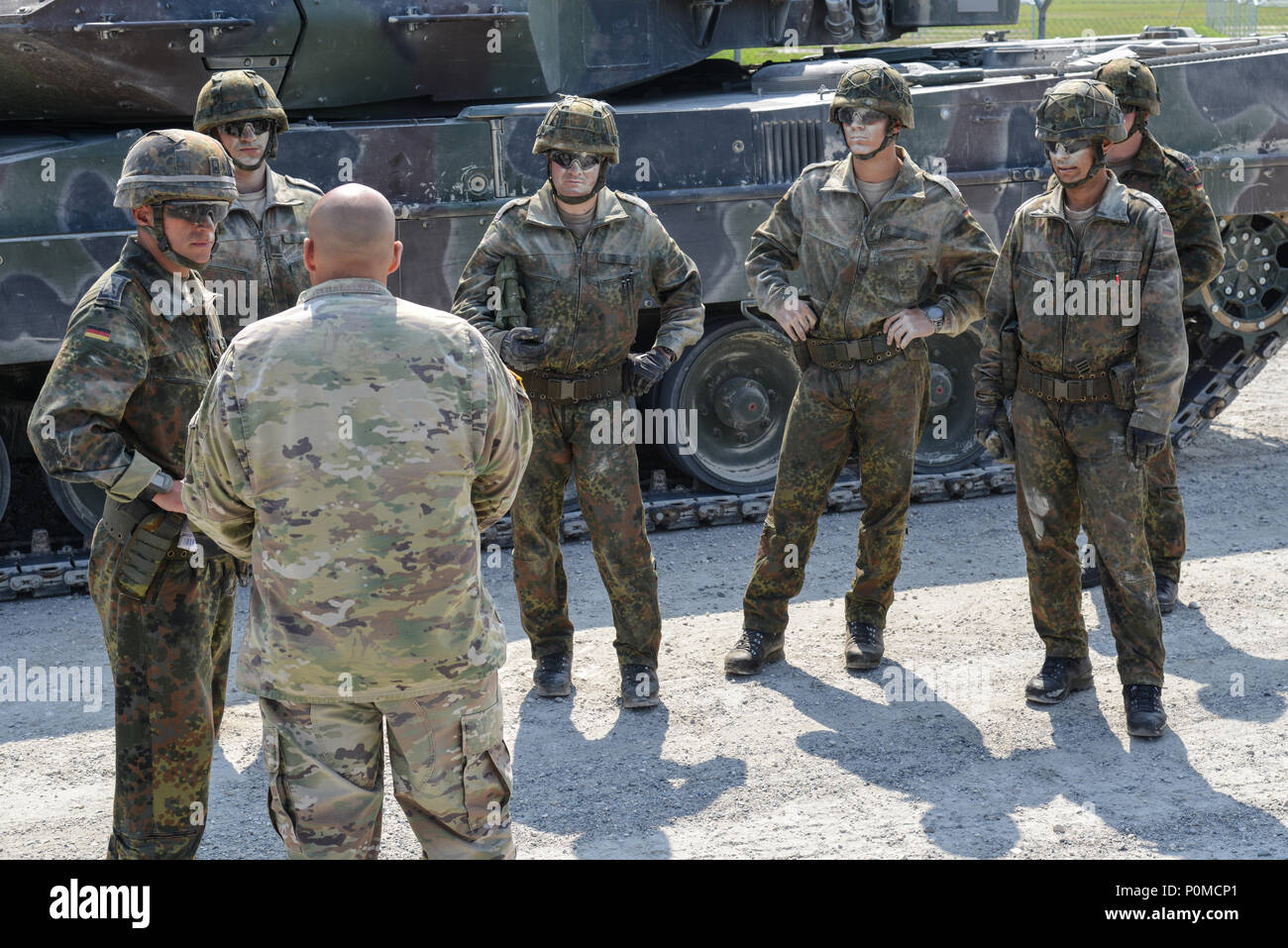 German soldiers assigned to the 3rd Panzer Battalion receive instructions  for the Medical Evacuation/Battle Damage Assessment and Repair lane during  the Strong Europe Tank Challenge, June 7, 2018. U.S. Army Europe and