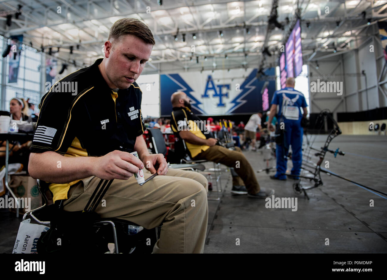 U.S. Army Sgt. Aaron Averre of Team Army applies lubricant to his arrow