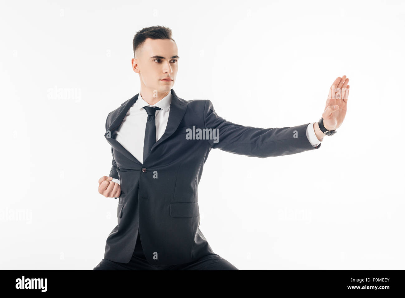 male karate fighter standing in position in suit isolated on white Stock Photo
