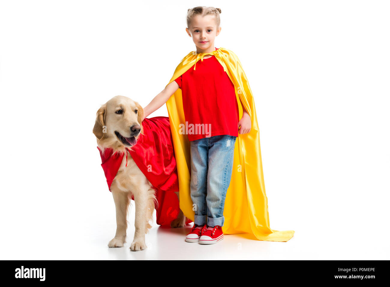 Dog in red cape with supergirl in yellow cape standing beside isolated on  white Stock Photo - Alamy