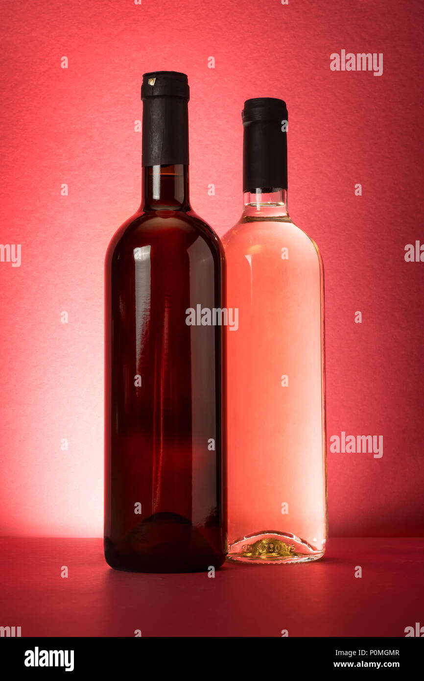Red and white wine bottles on red background Stock Photo Alamy