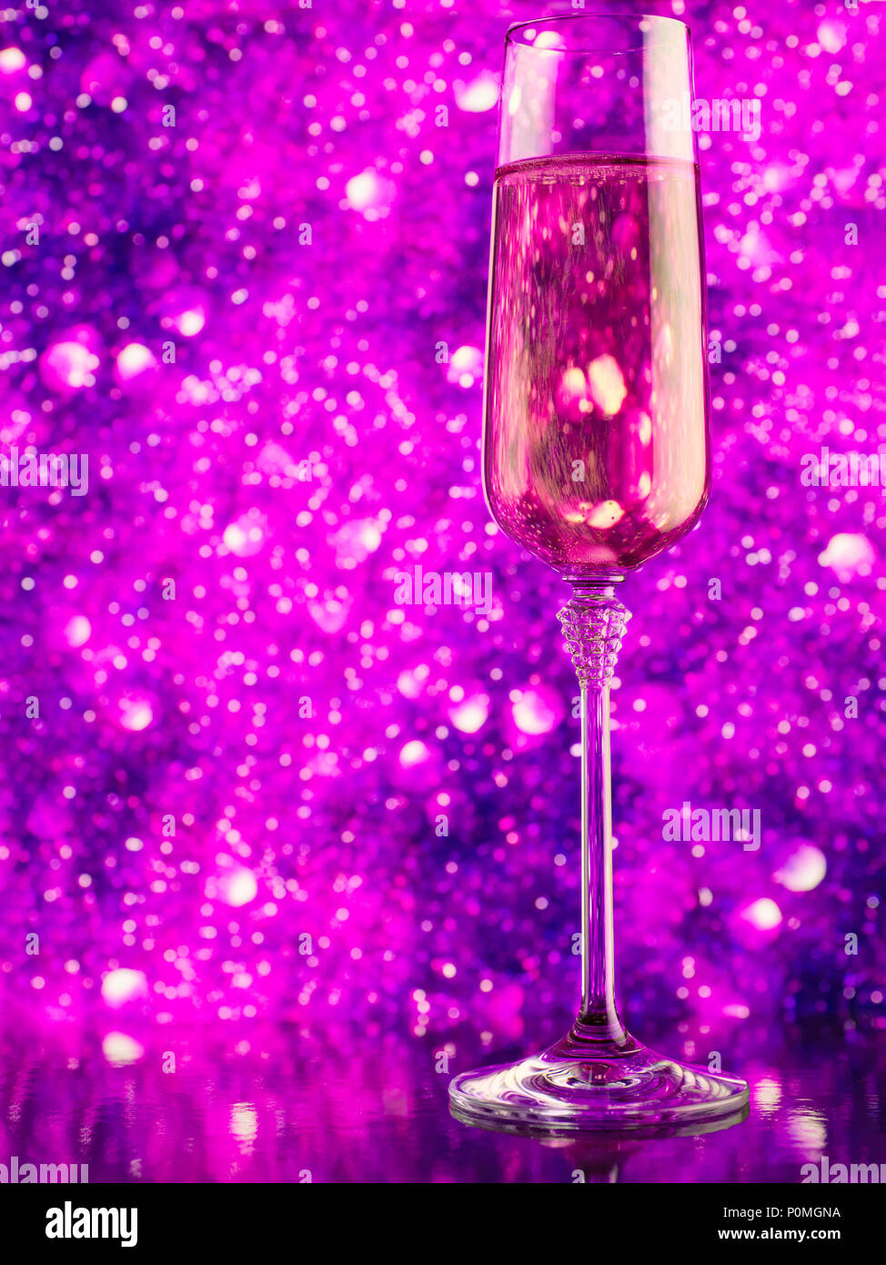 Glass of sparkling wine against purple abstract defocused background Stock Photo Alamy